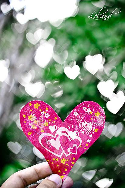 Paper heart in front of daylight heart bokeh