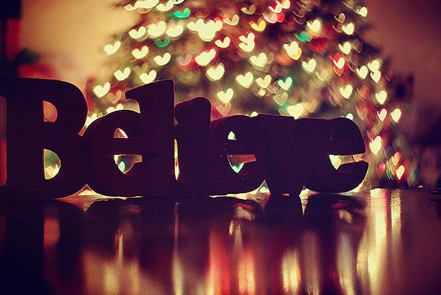 Believe statue in front of Christmas tree bokeh